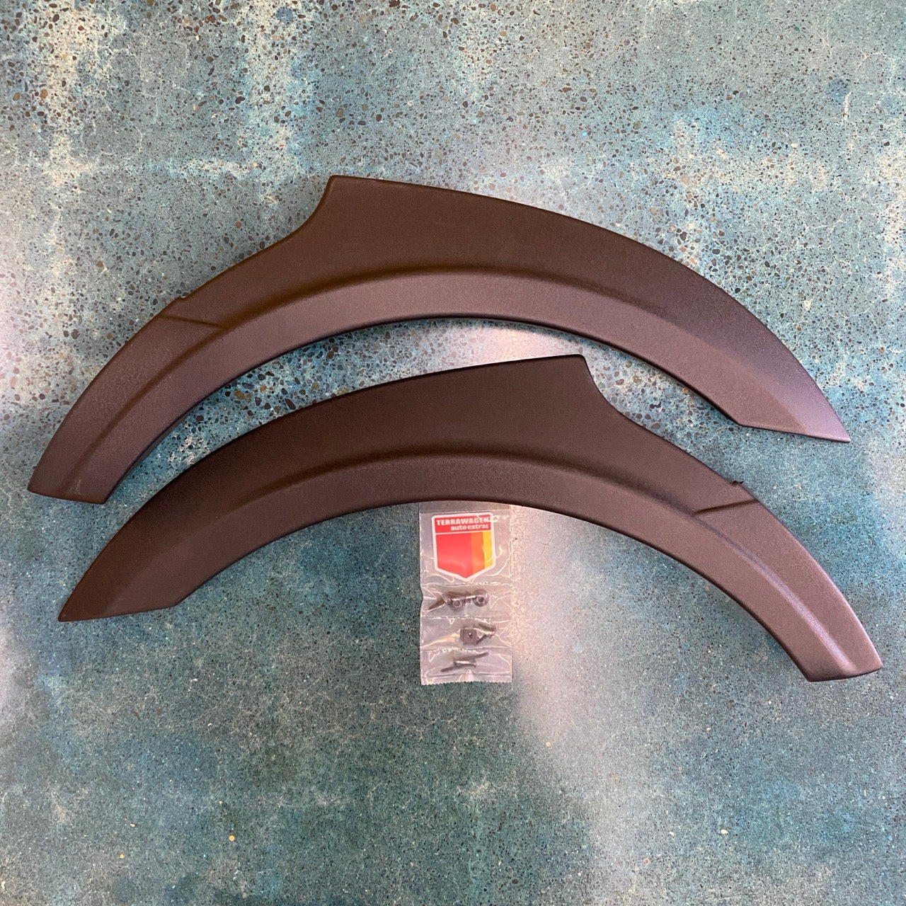 Rally Raider front fender flares laid out – front pair with hardware