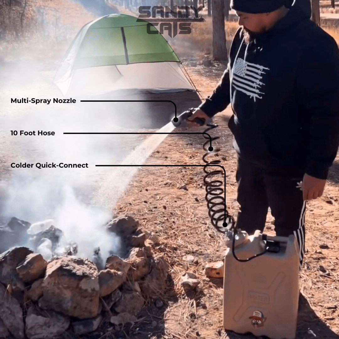 Person using TrailWash system with multi-spray nozzle, 10-foot coiled hose, and Colder quick-connect to extinguish a campfire